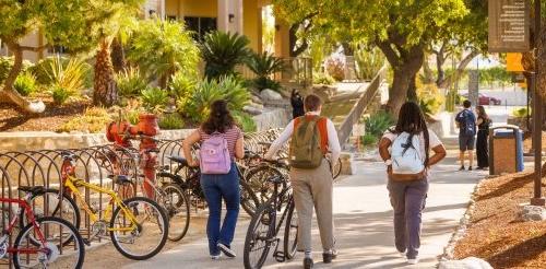 Students walk their bikes down the Avery walkway